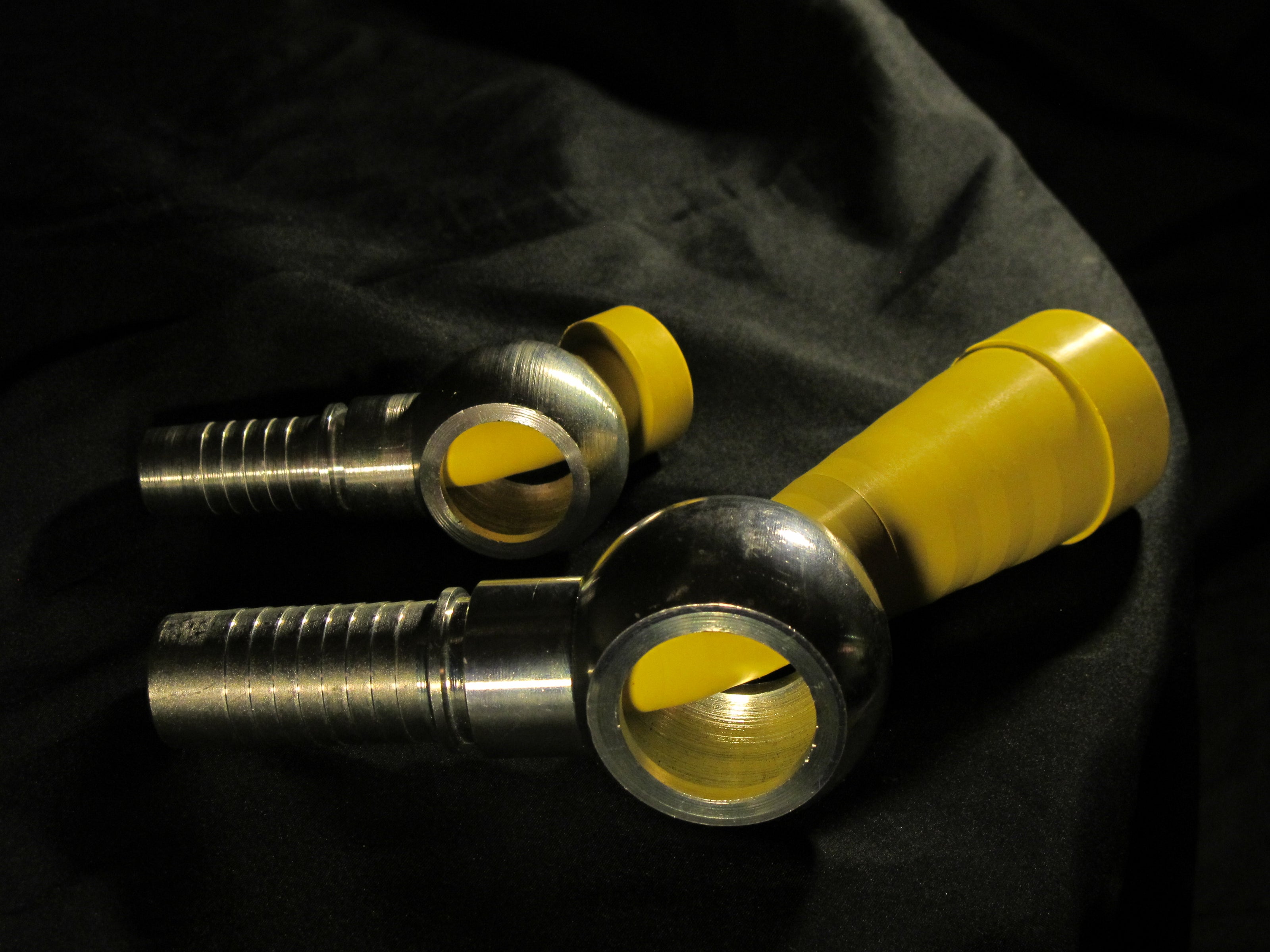 Secure sealing: Yelloc XL and Standard plugs inserted into industrial banjo connections.